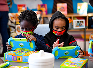 Photo of boys using literacy tablets